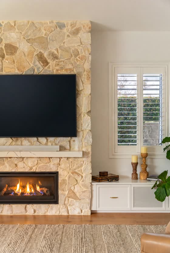 Living room with a stone fireplace