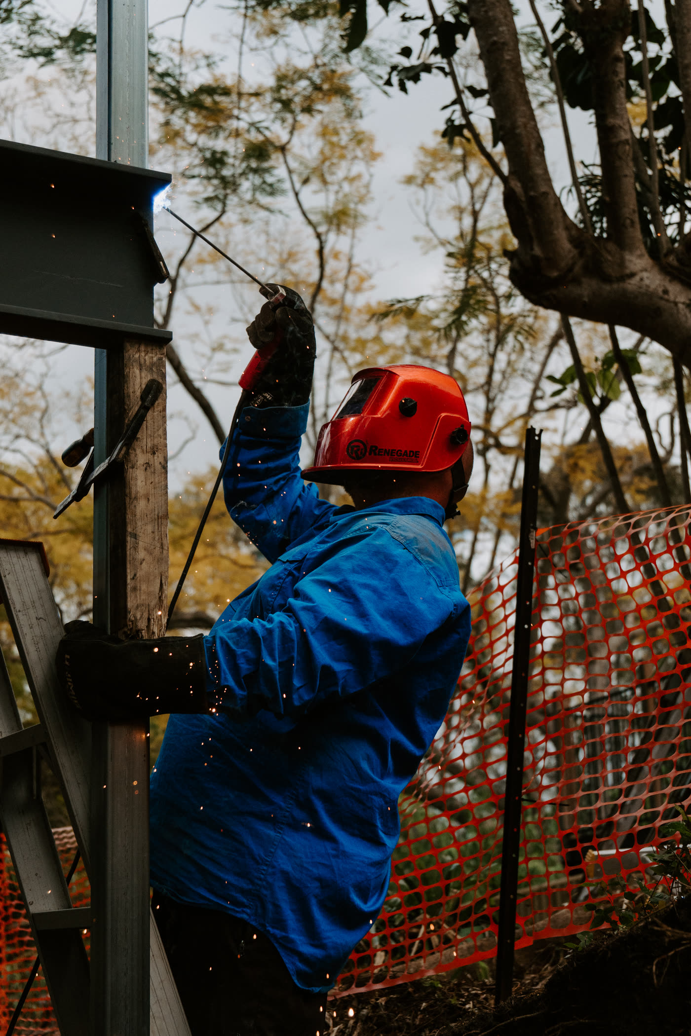 Elevate House Raising welder working on a steel beam